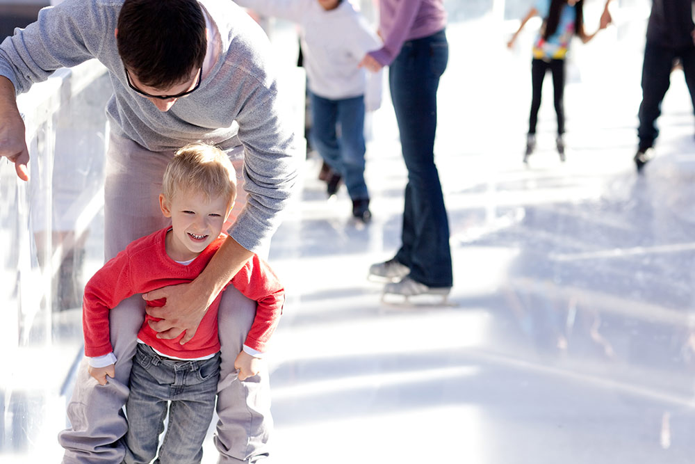 Dad skating with boy